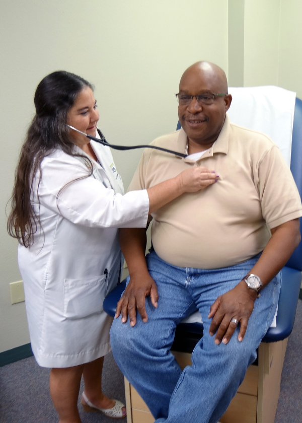Dr. Mavra Kear examines a mock patient at PRC's Wellness Clinic
